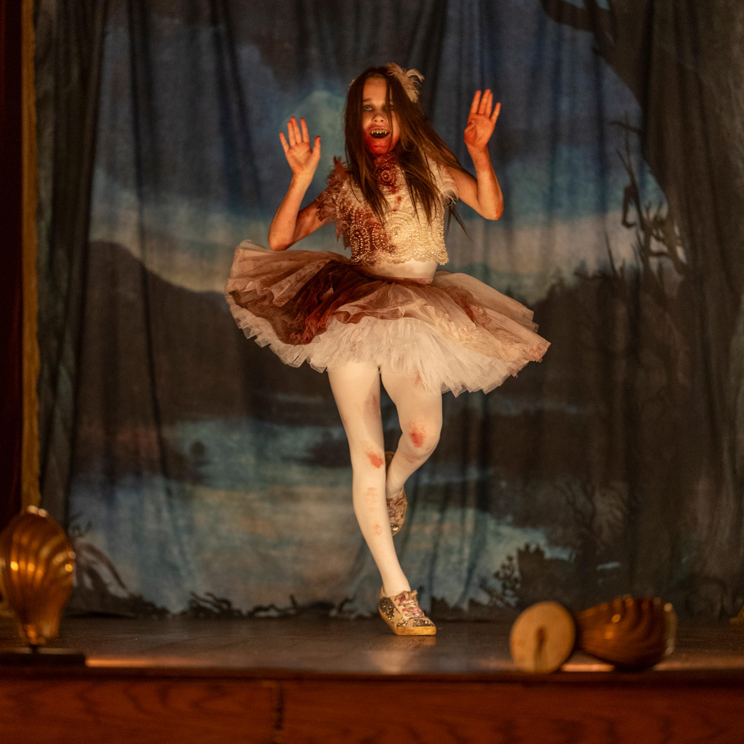 Young girl in a tutu covered in blood