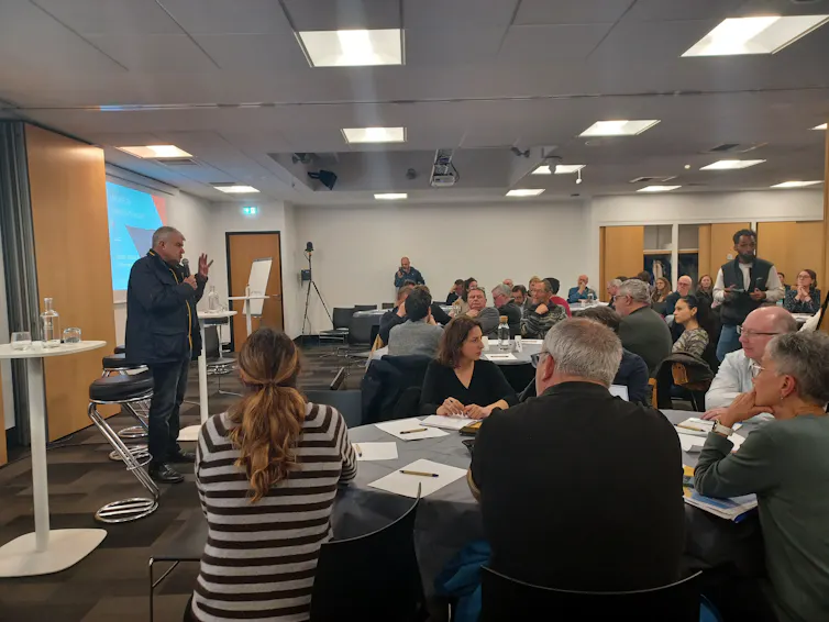 photo d’une conférence à laquelle assistent une vingtaine de personnes