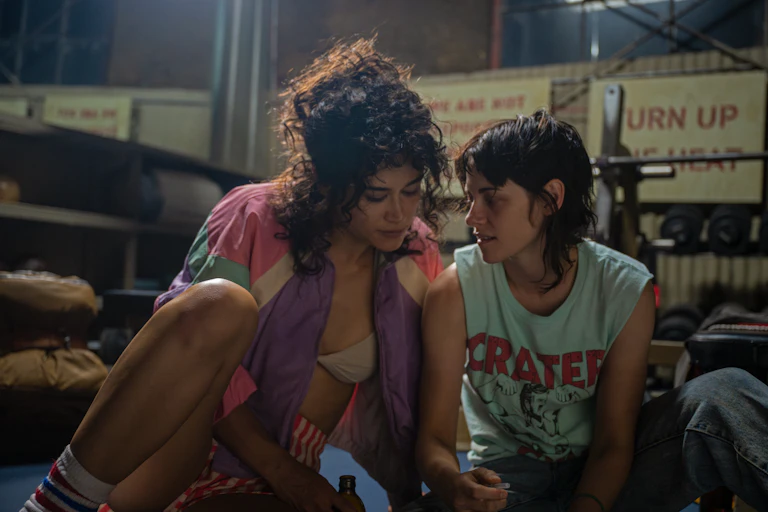 Two women in a gym looking at each other affectionately