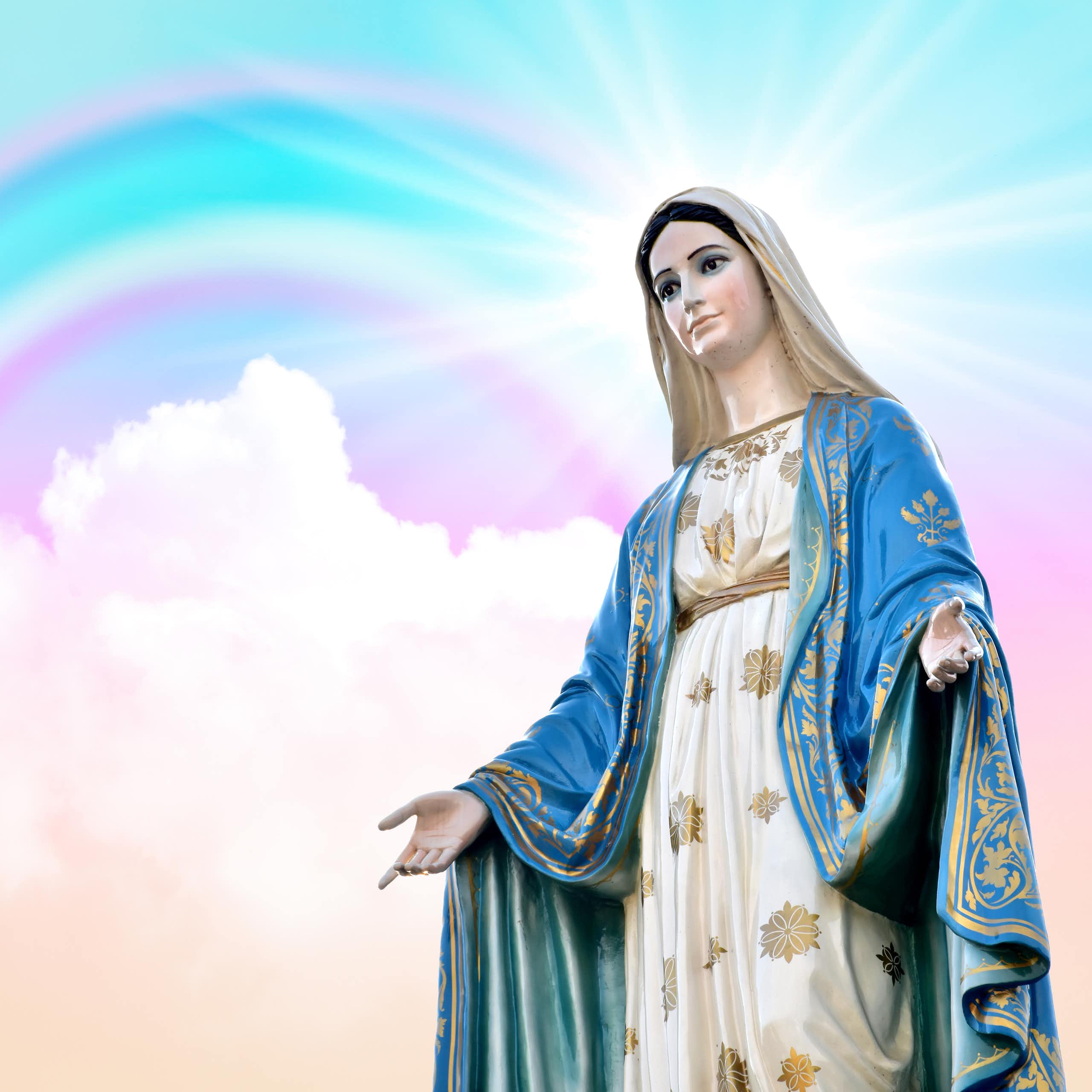 Image of Virgin Mary surrounded by pink and blue sky and rainbow.