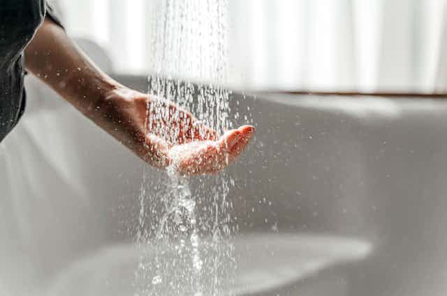 A  hand under a shower of water.
