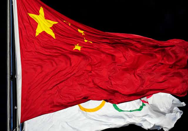 The Chinese and Olympic flags flutter together
