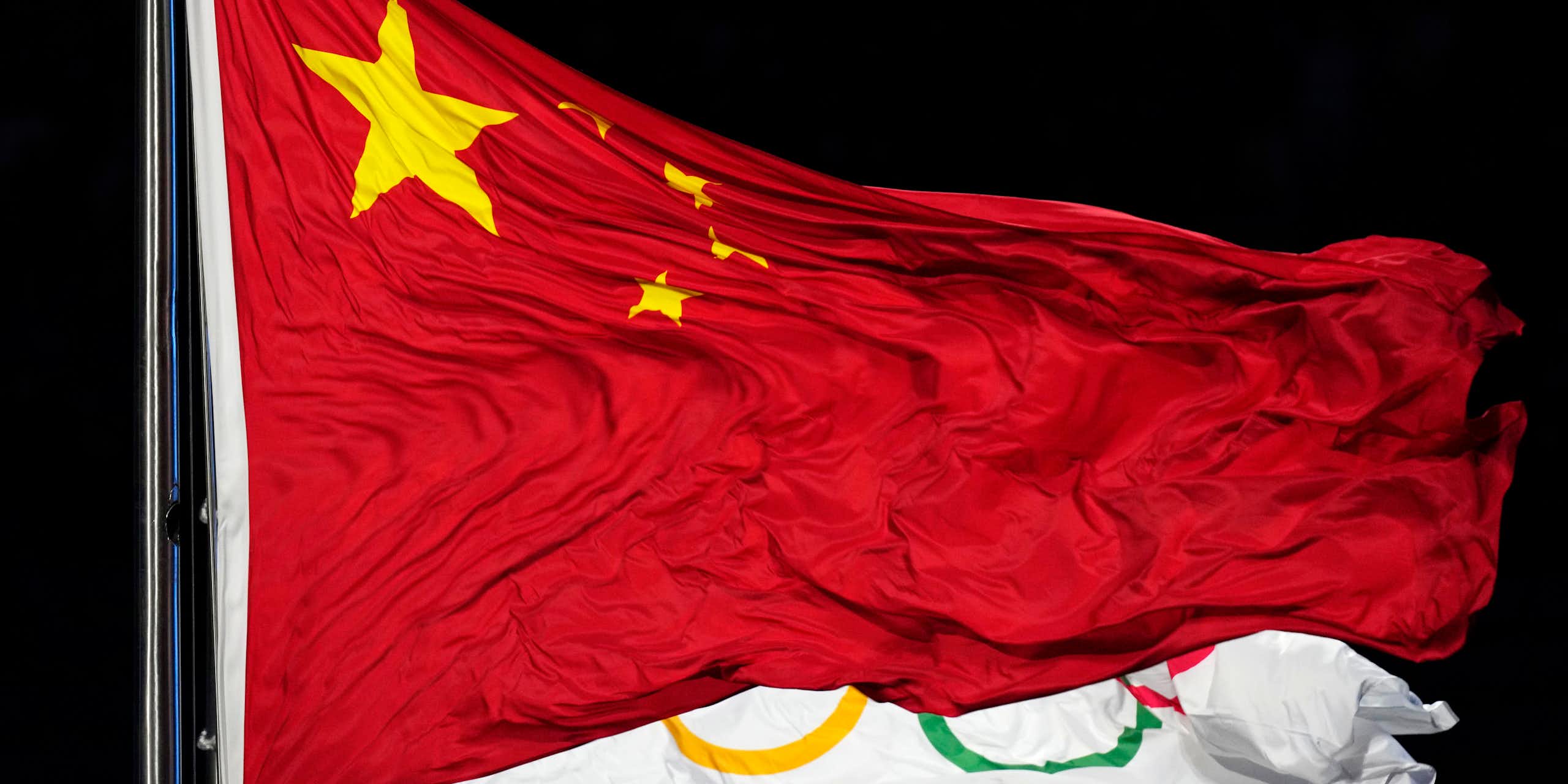 The Chinese and Olympic flags flutter together