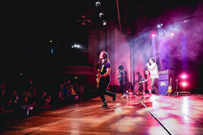 Band performing in photo taken from side of stage