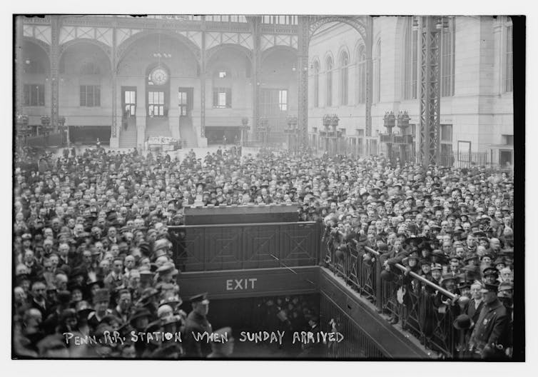 Crowds fill the central hall of New York's old Penn Station.