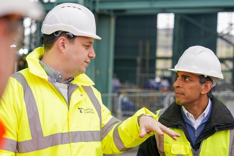 Ben Houchen and Rishi Sunak wearing hard hats and high-viz jackets.