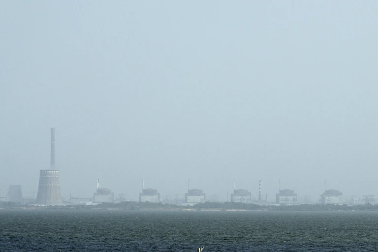 A power plant is seen across a river.