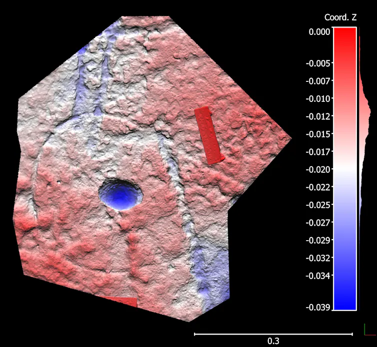 A red and blue scale bar pictured next to a scan of a small piece of what looks like rock, also in red and blue