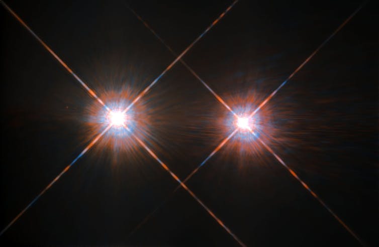 two bright stars against a dark background