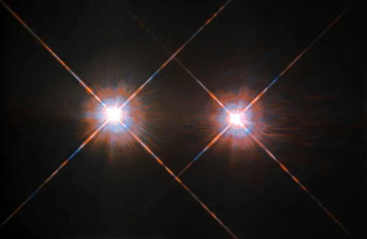 two bright stars against a dark background