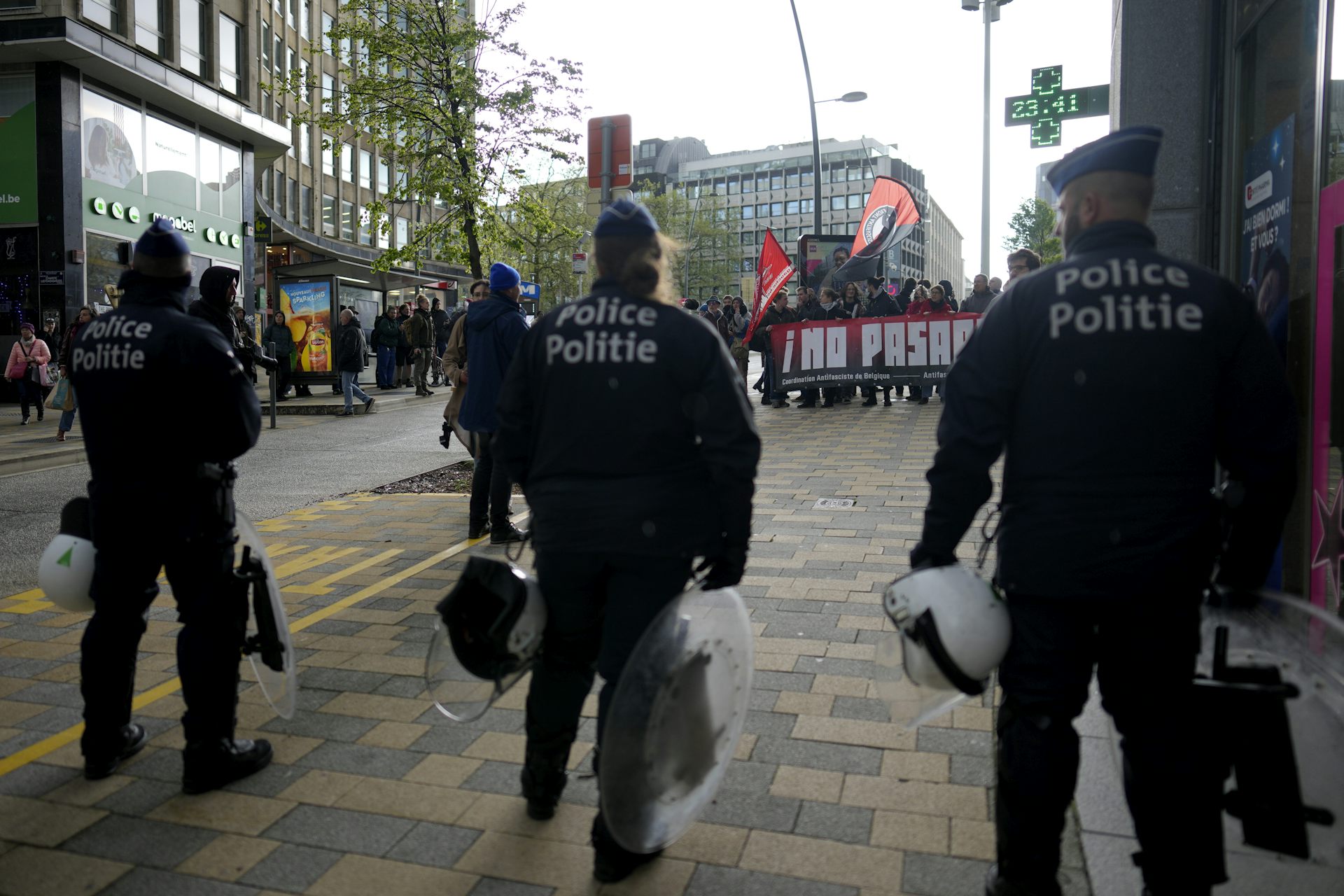 Police officers look towards a crowd of protesters.