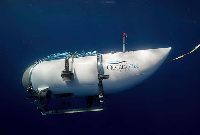 a small submarine in the ocean with the words Ocean Gate titan writen on it.
