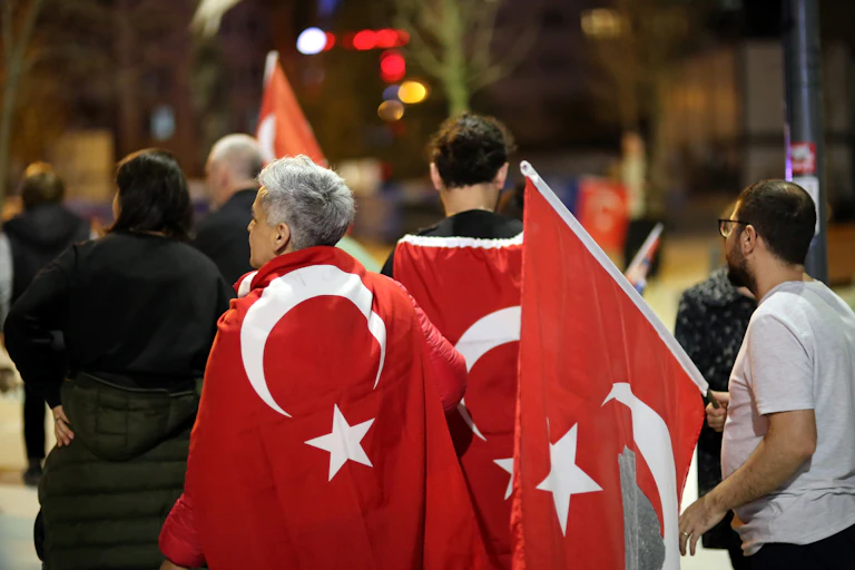 Turkish citizens waving Turkish flags and celebrating the results of the 2024 elections.