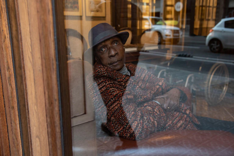Maryse Conde photographed through a window