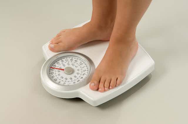 A person standing on bathroom scales