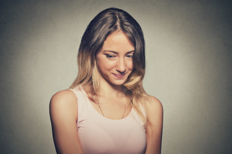 Young woman, avoiding eye contact, looking sideways and down