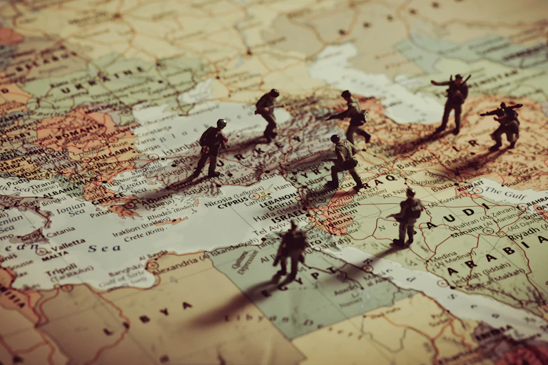 Toy soldiers positioned over the top of a map of Europe and the Middle East.