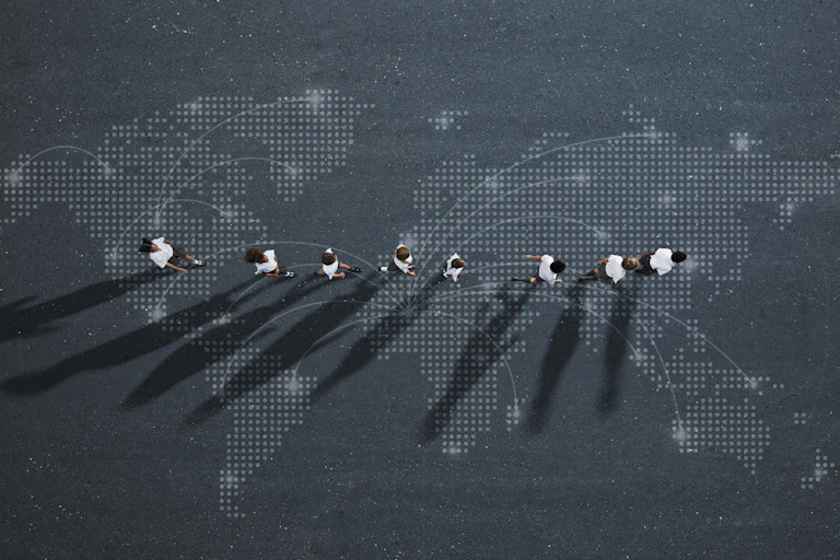 An illustration showing a digitally rendered world map with a row of children walking along the centre, lines linking them to various places.