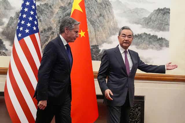 US secretary of state Antony Blinken and China's Foreign Minister Wang Yi in front of flags in Beijing on April  26.