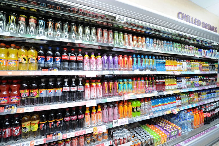 A supermarket aisle selling soft drinks.