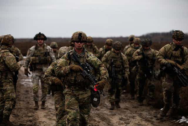 US soldiers running towards the camera.