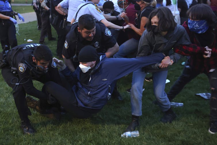 Police scuffle with student protesters.