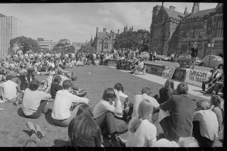 Students sitting on the lawn.