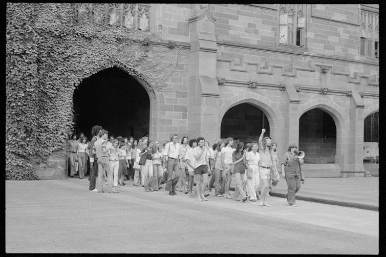 Students march through campus.