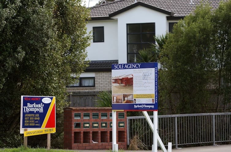 House with rent signs in front.