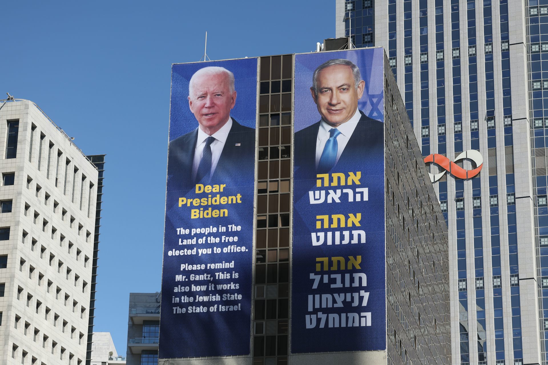 Posters of US president, Joe Biden, and Israeli prime minister, Benjamin Netanyahu, on a skyscraper in Tel Aviv.