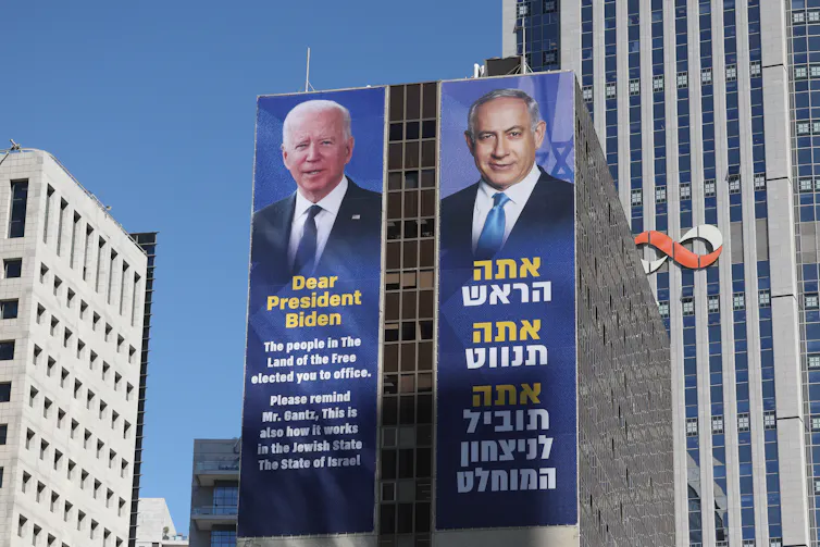 Posters of US president, Joe Biden, and Israeli prime minister, Benjamin Netanyahu, on a skyscraper in Tel Aviv.