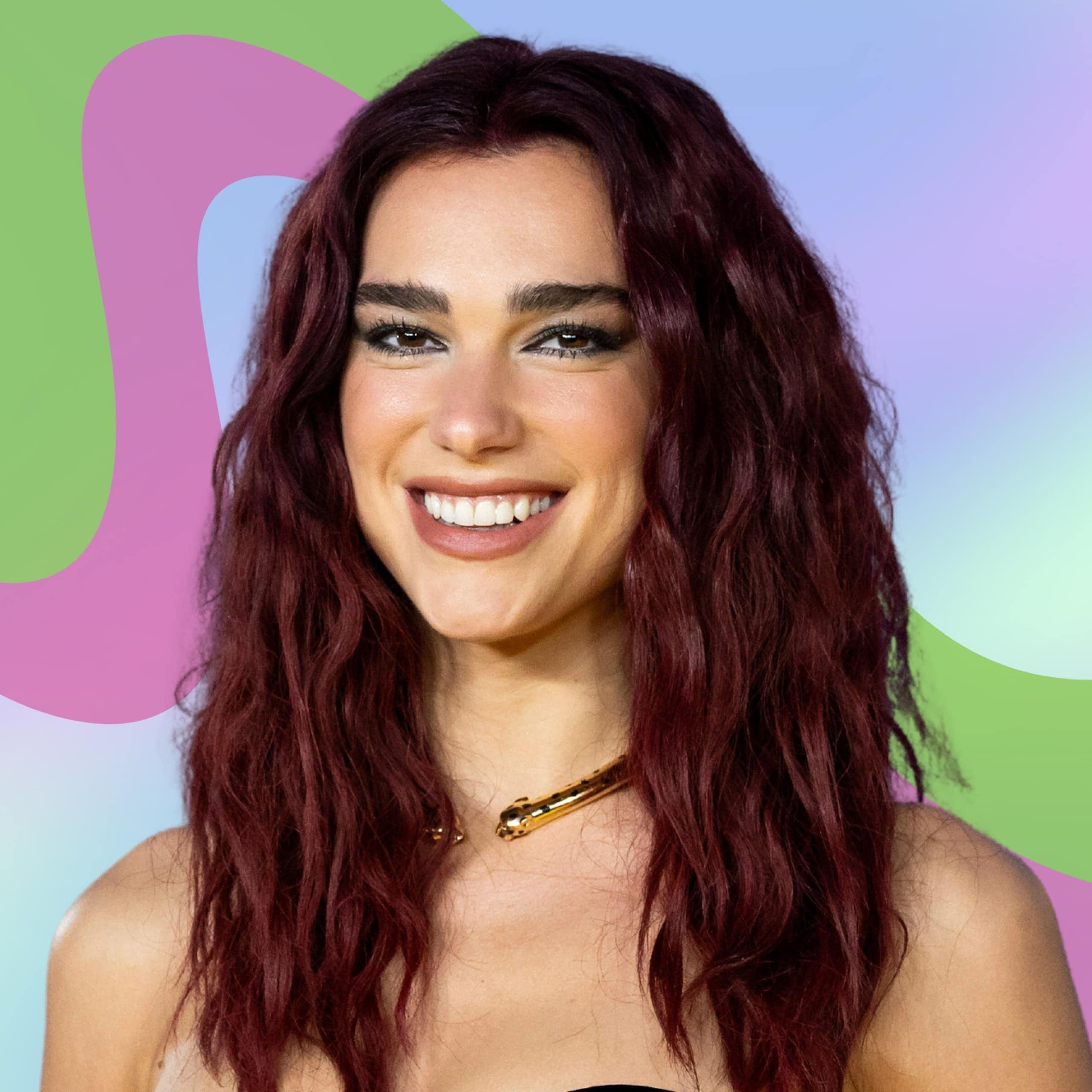 Dua Lipa smiling with a pattern behind her