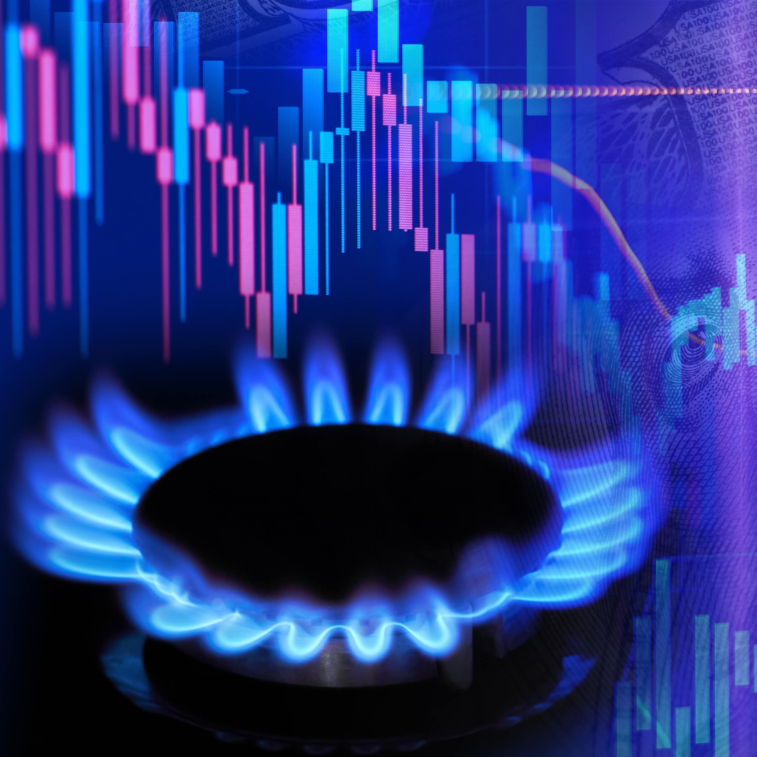 blue gas ring flames lit, background with computer generated pink and blue stock chart graph to indicate rising costs