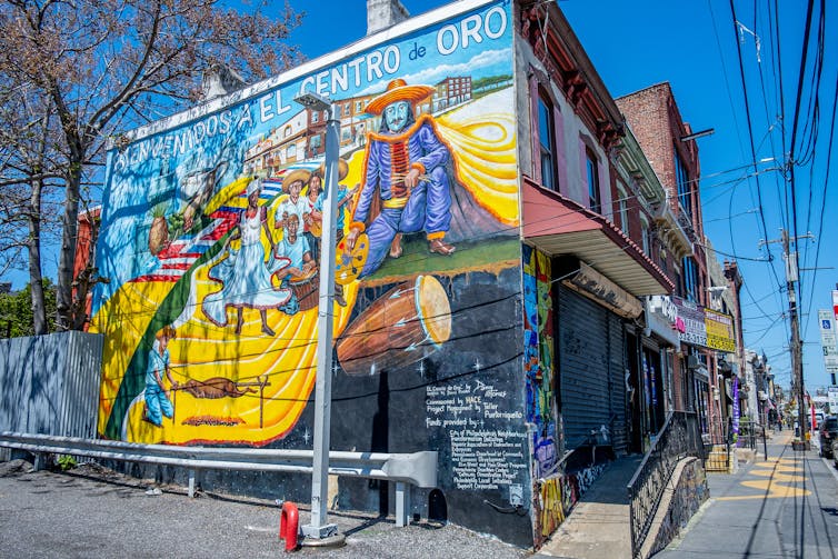 A colorful mural reads 'Bienvenidos a El Centro de Oro' in North Philadelphia
