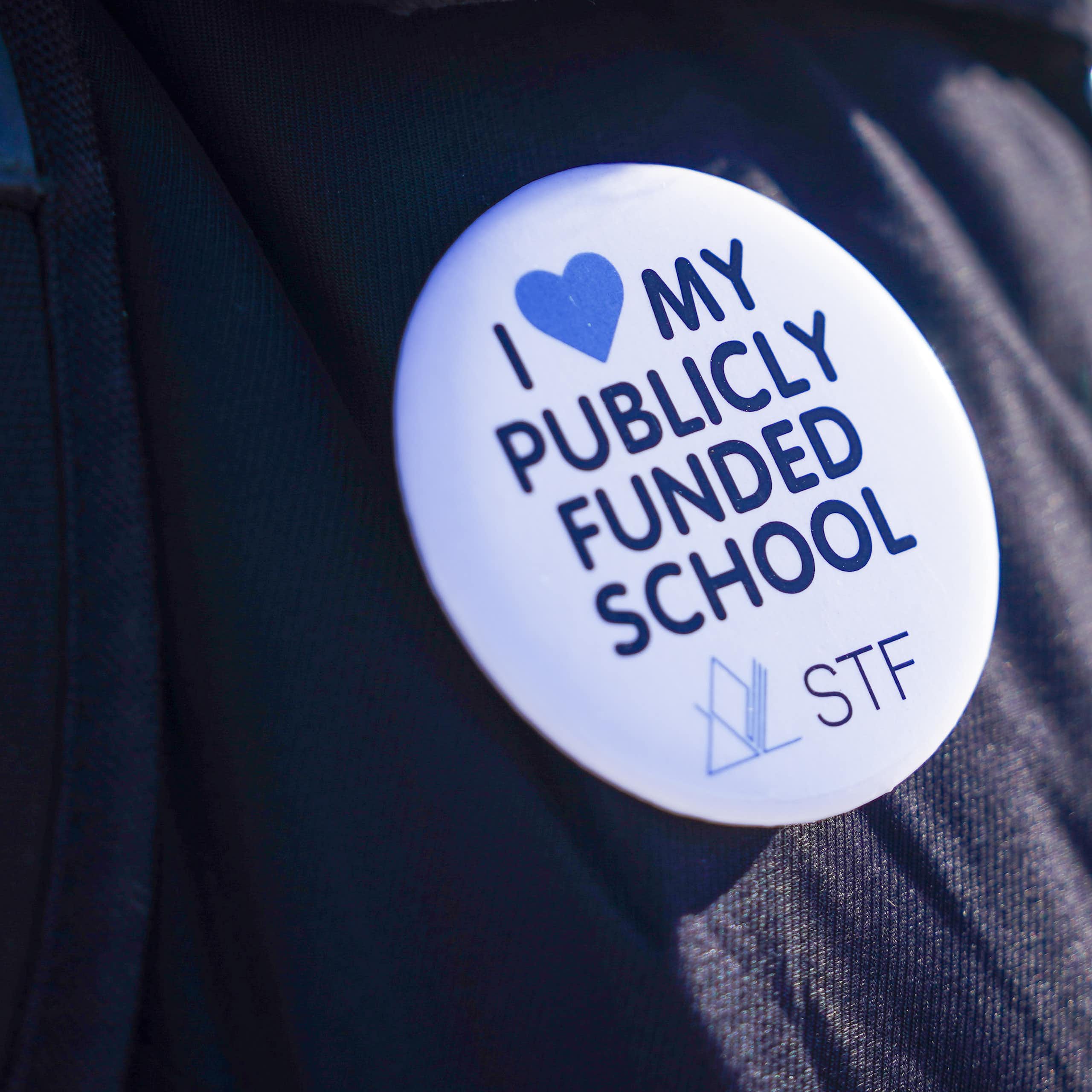A button says I heart my publicly funded school.