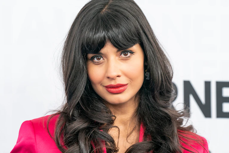 Actress Jameela Jamil poses on a red carpet.