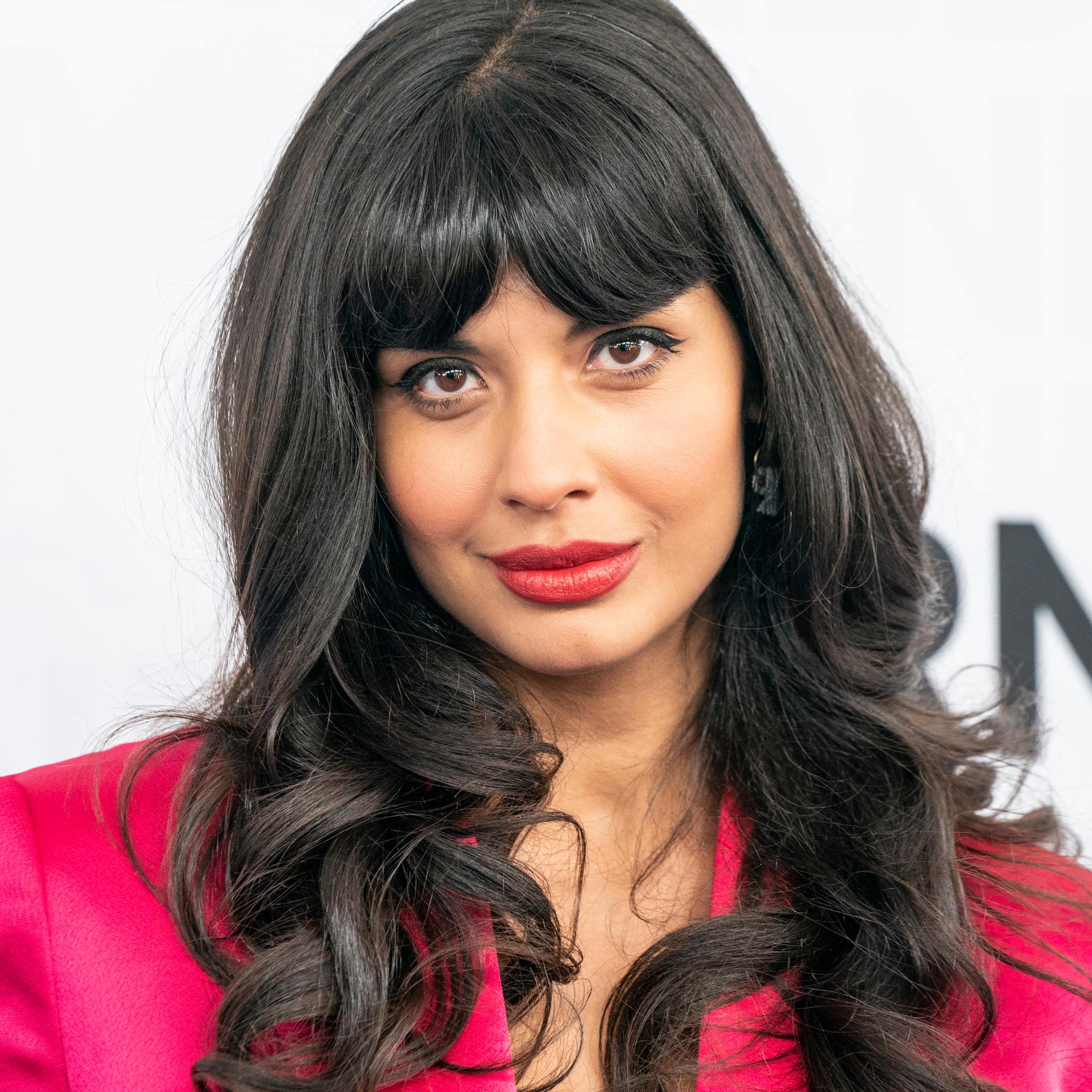 Actress Jameela Jamil poses on a red carpet.