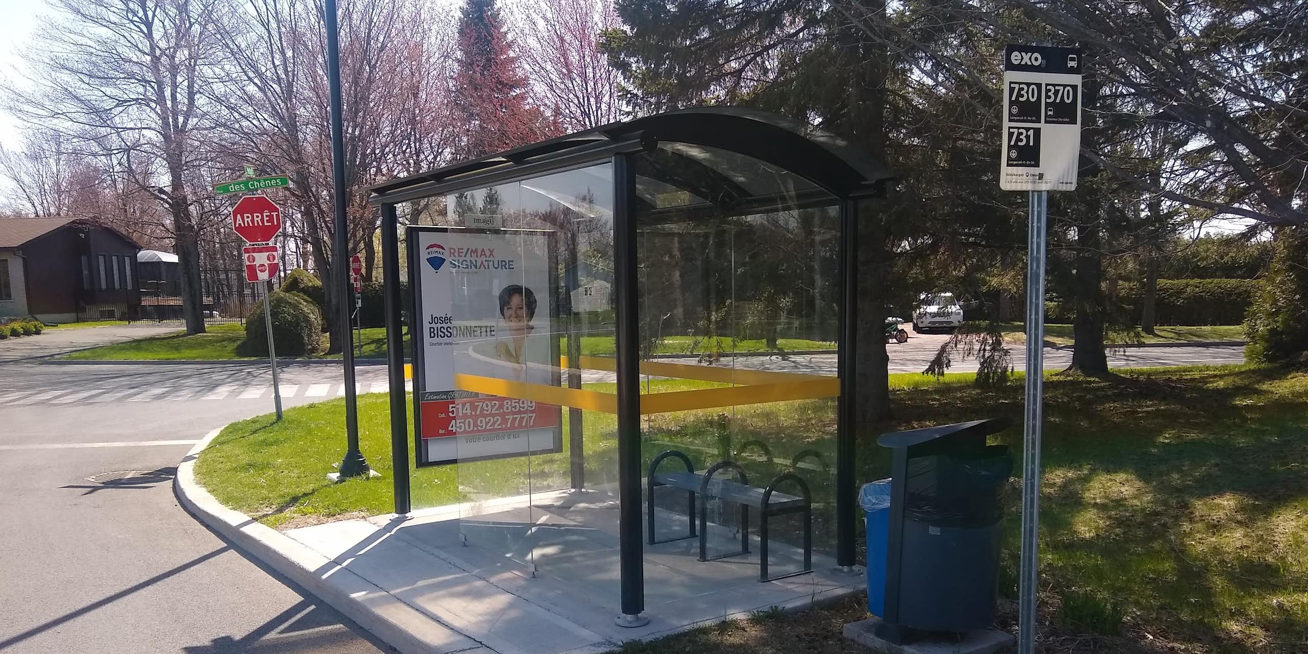 an empty bus stop in a suburban neighbourhood