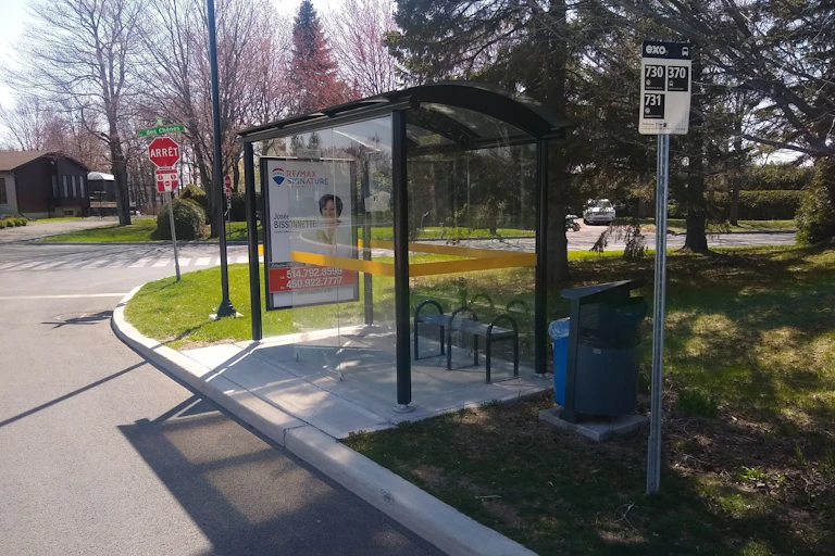 an empty bus stop in a suburban neighbourhood