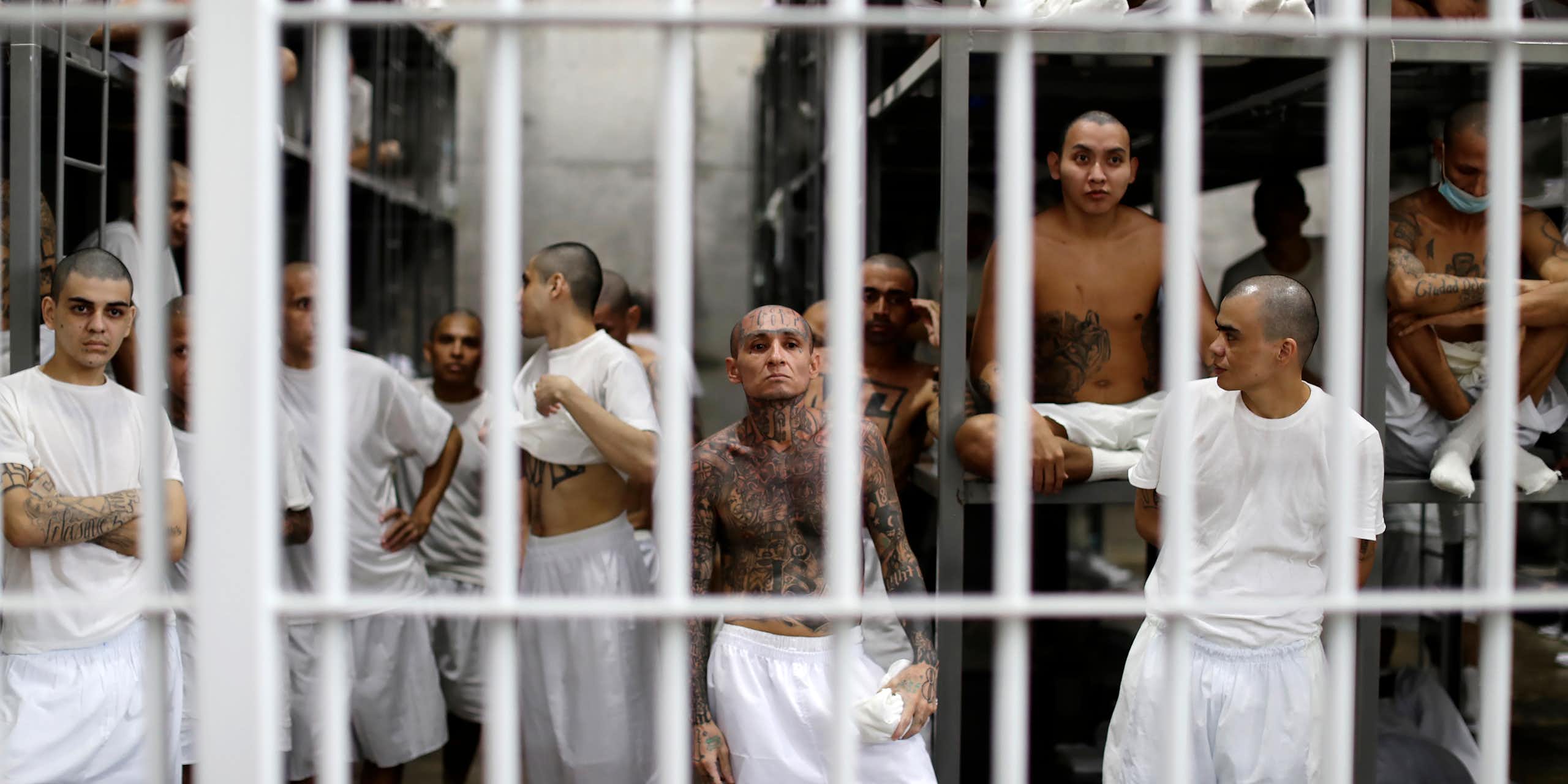 A group of heavily tattooed gang members in their prison cell.