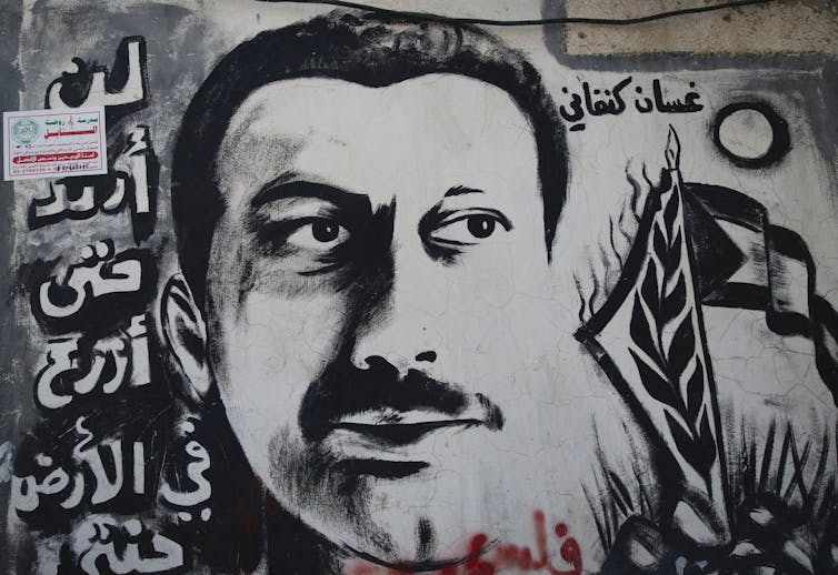 Black and white mural of young man with mustache.