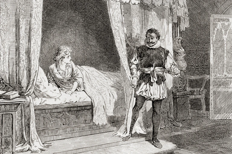 A white woman lies in bed as a Black man stands near her.