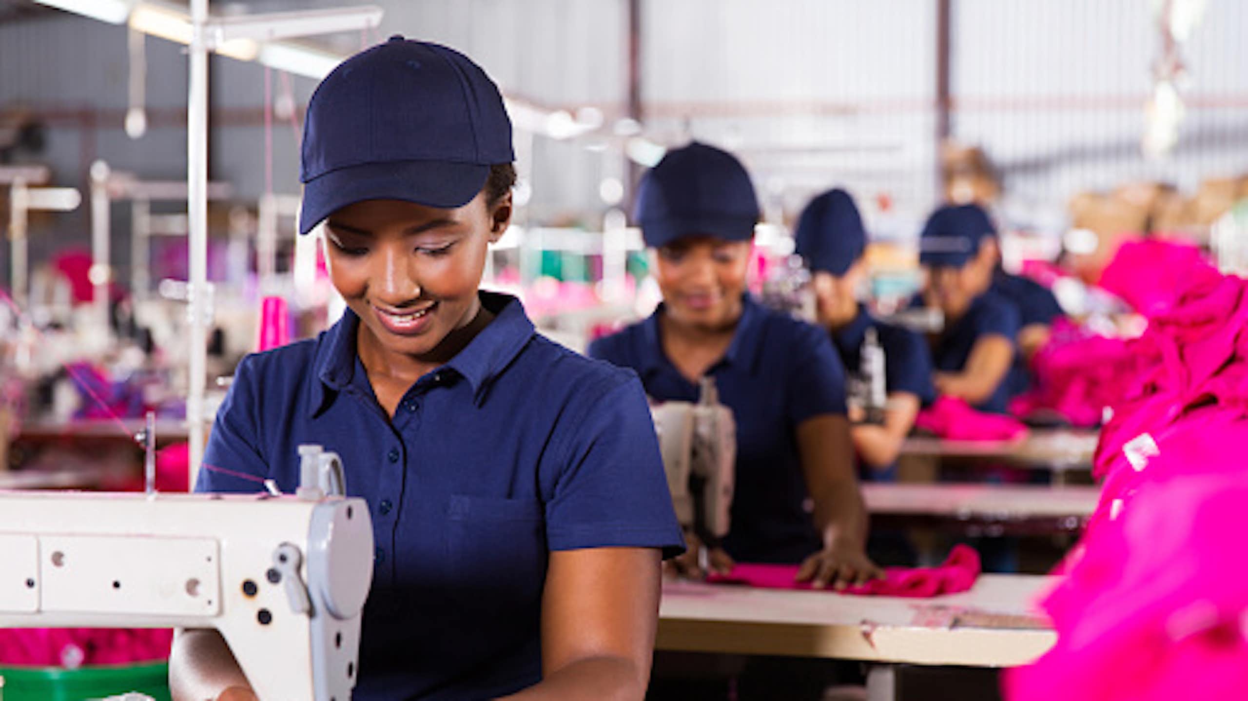 African workers sewing cloths at a textile factory