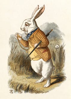 A rabbit in a tweet suit jacket holds a walking stick and studies a pocket watch.