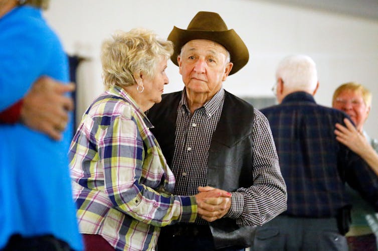 An older couple dances.
