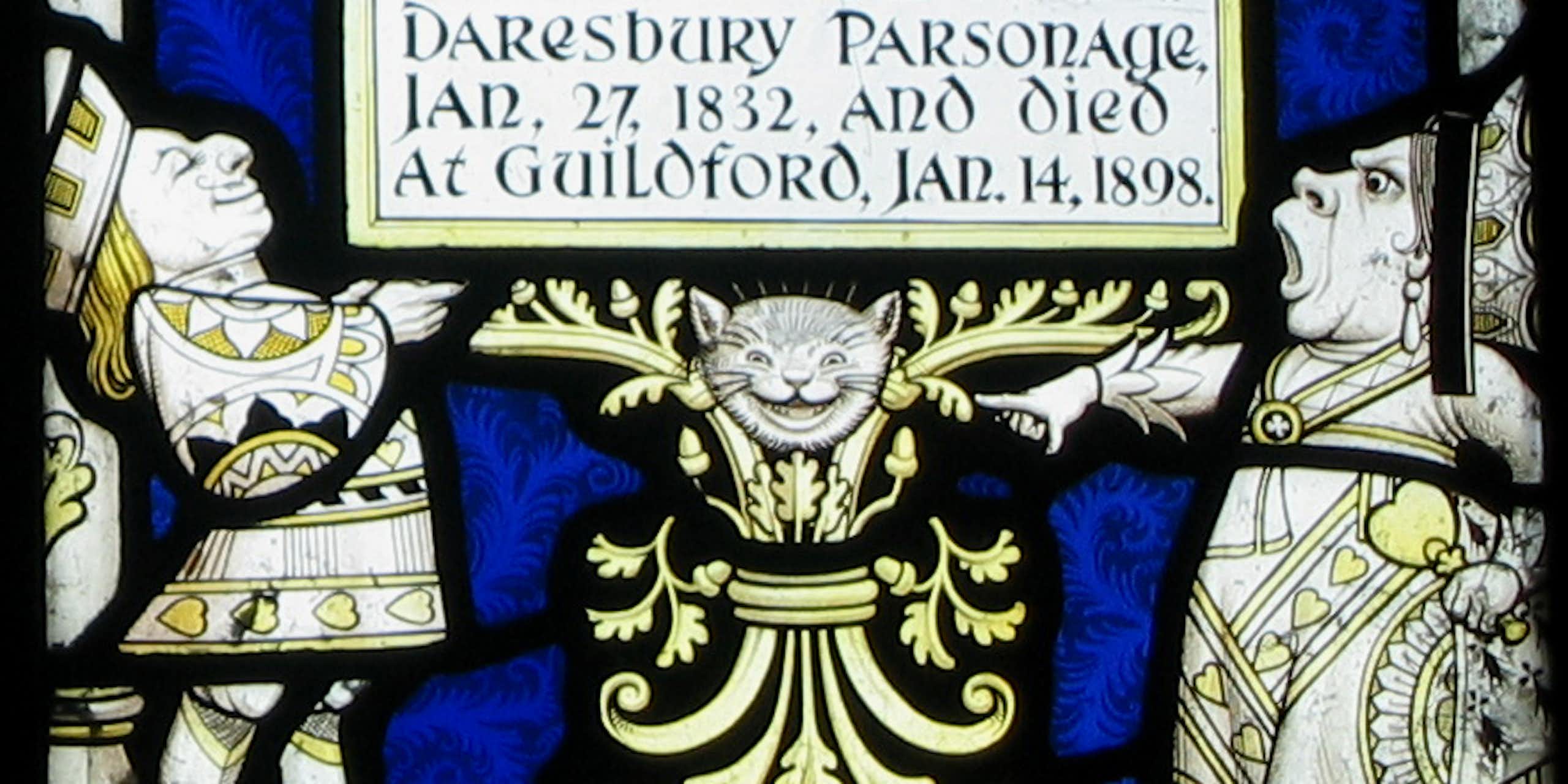 Yellow and white figures of a man and woman in fancy robes and a grinning cat's head.