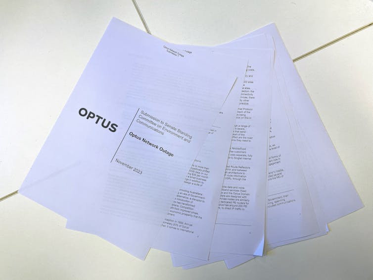 Photo of a sheaf of paper containing a submission to a parliamentary committee regarding the Optus outage.