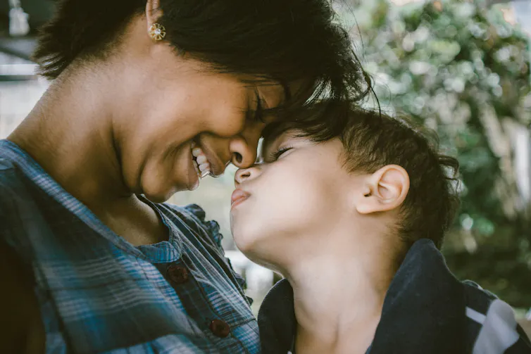 Boy snuggles into his mum