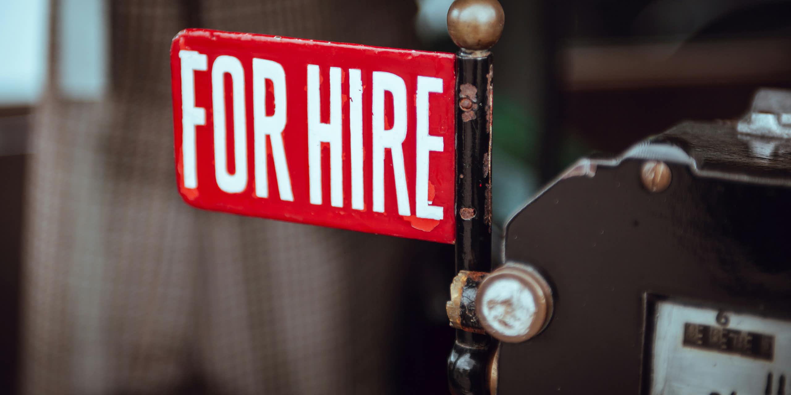 A small red flag with text that says for hire.