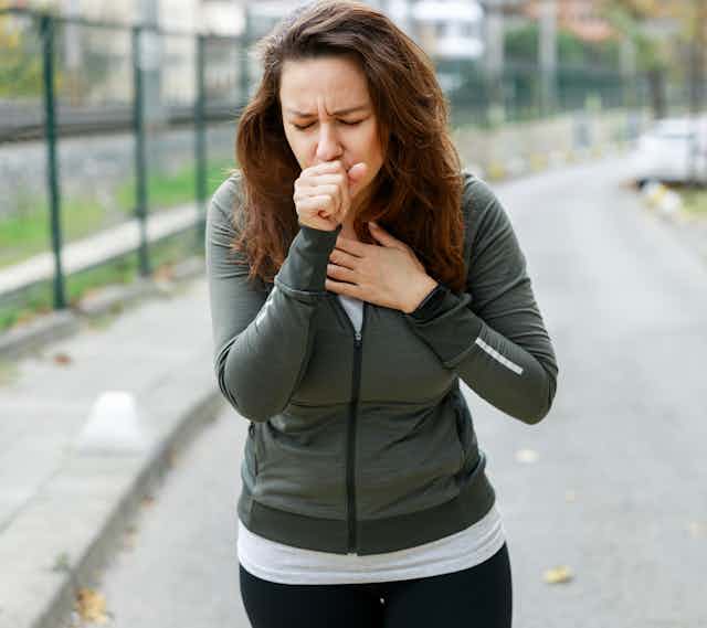 woman running coughing pollution